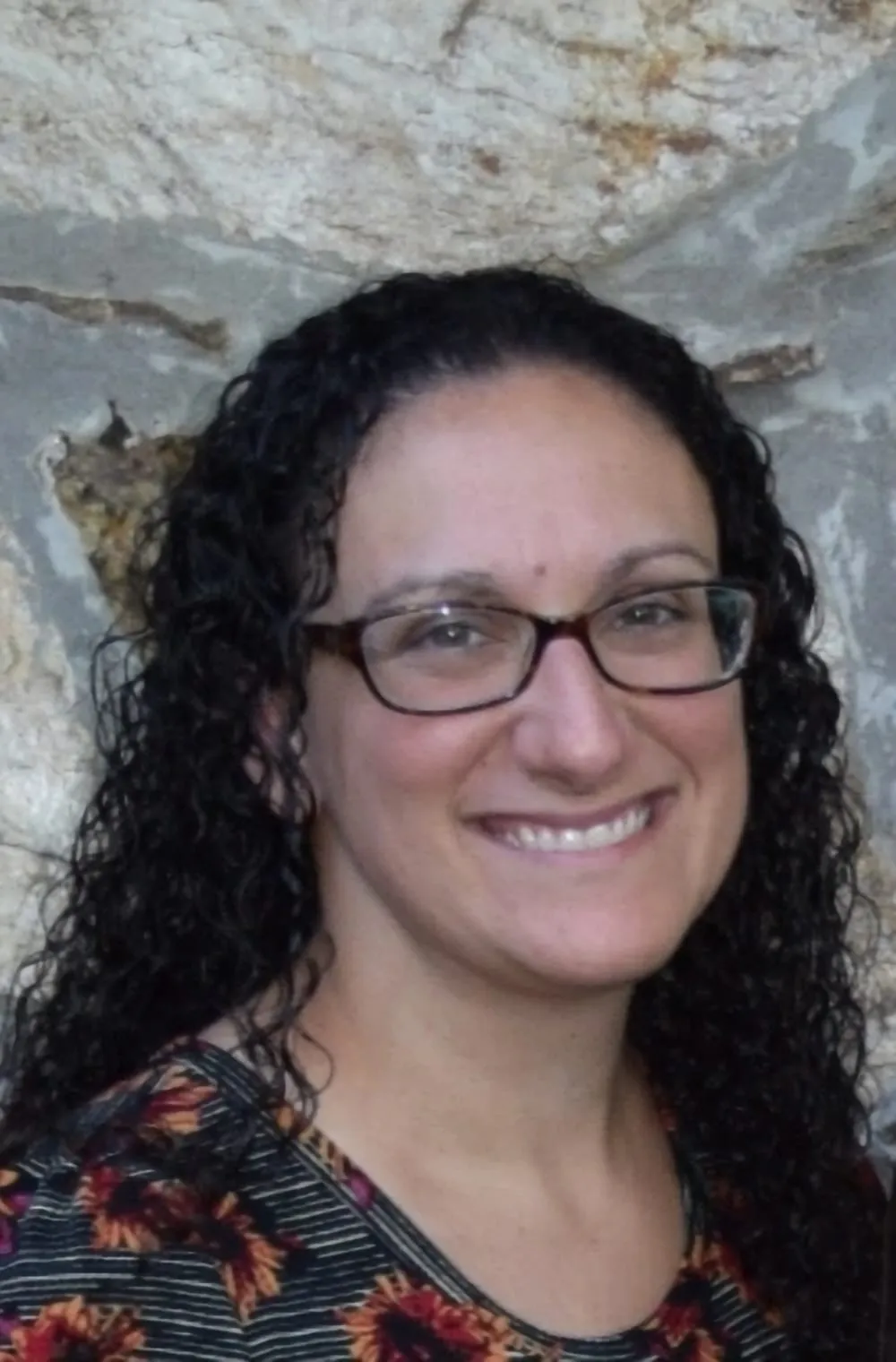 Dr. Lauren Heagy standing against a stone wall